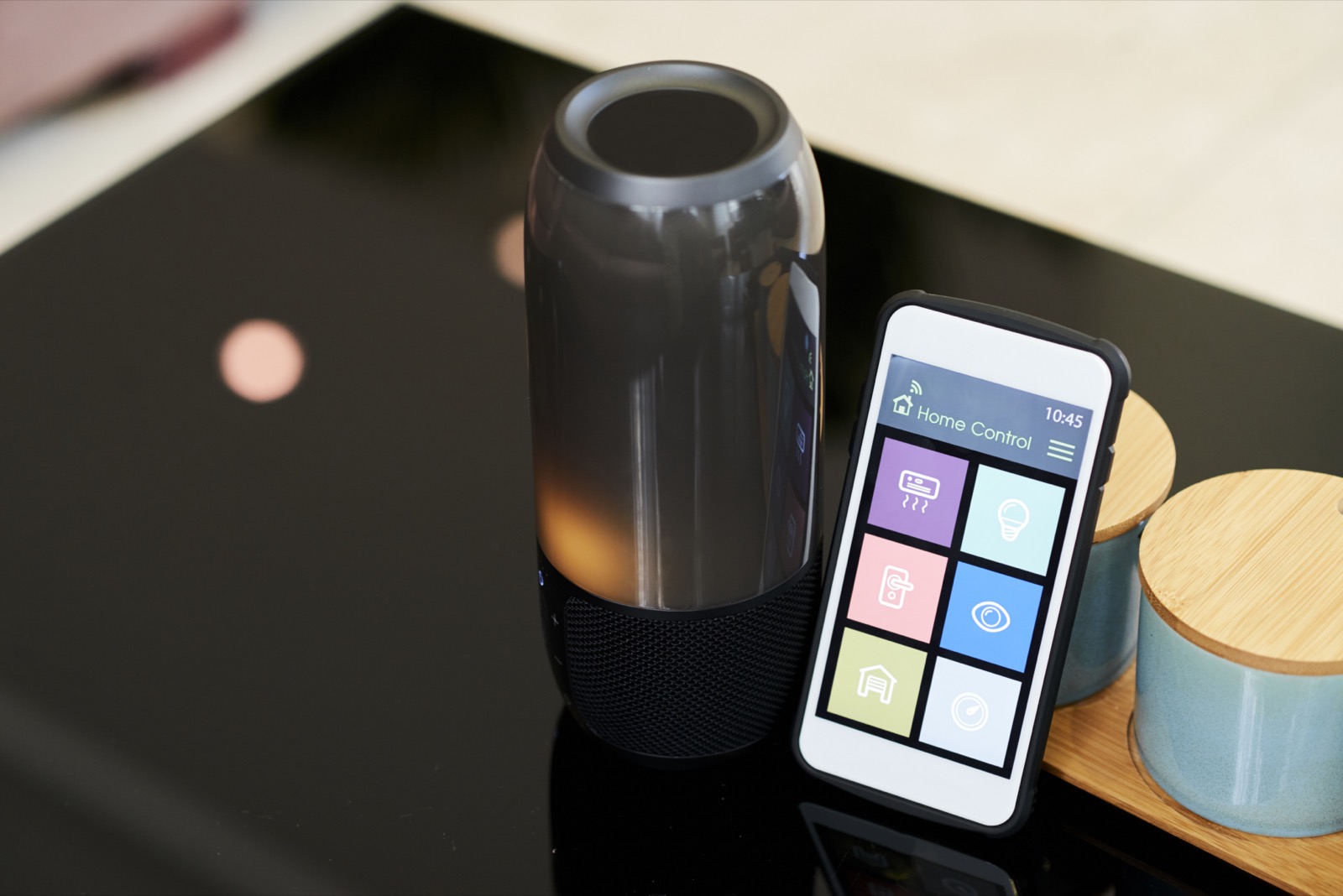 A portable Bluetooth speaker paired with a phone app for adjusting playback