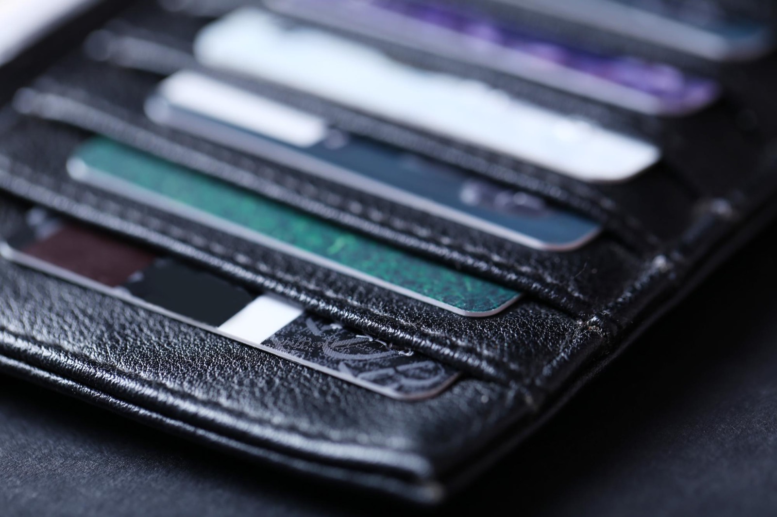 Close-up of credit cards stacked inside a leather wallet