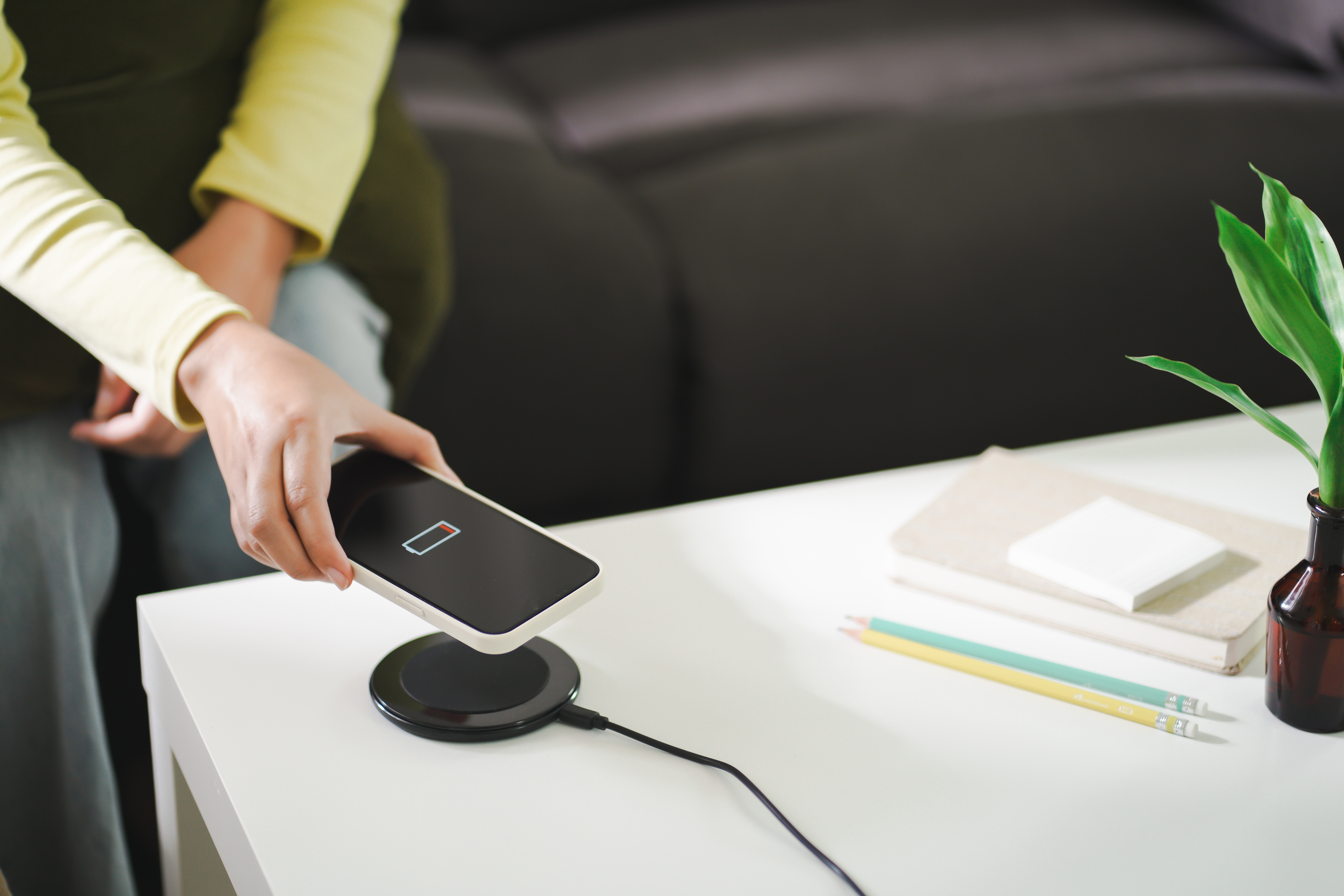 iPhone in a case charging on a wireless charging pad